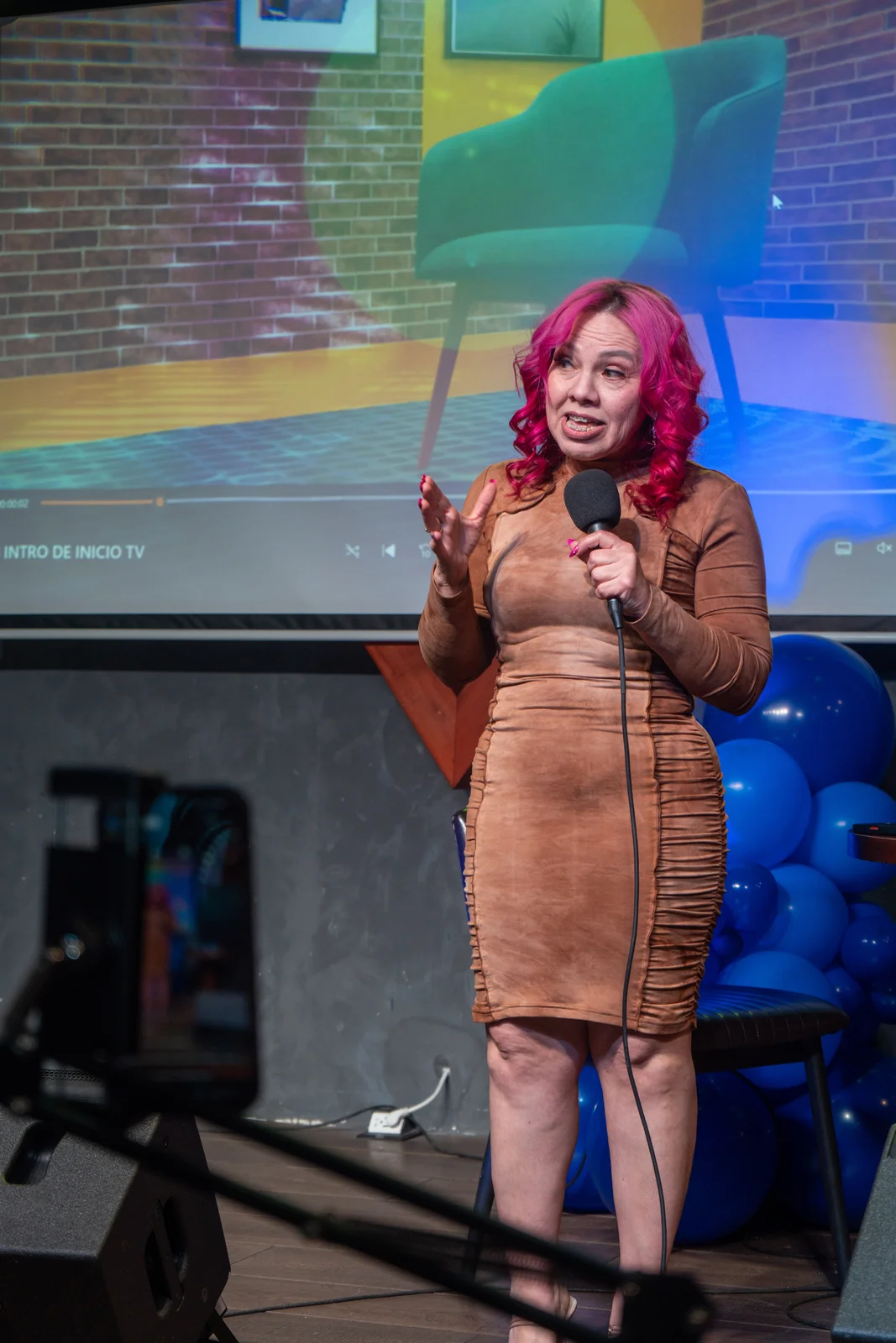 A speaker on stage at a creator podcast event