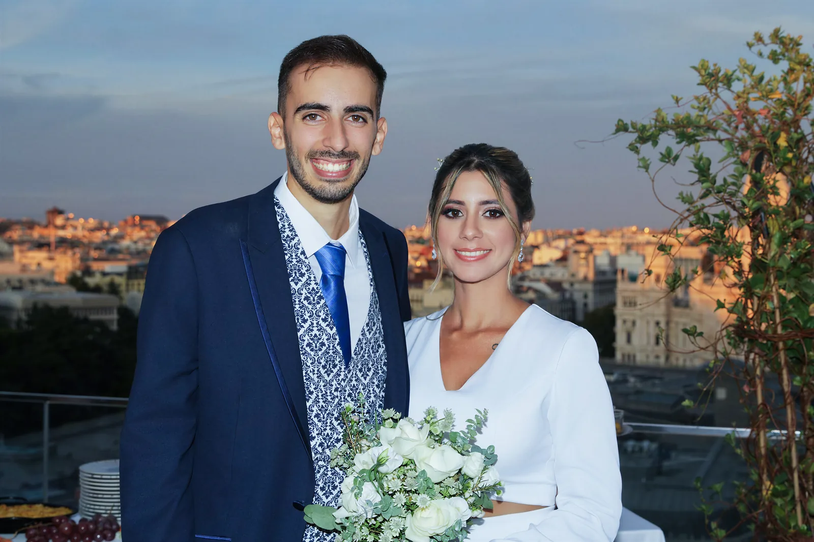 The couple at sunset on a rooftop above the city